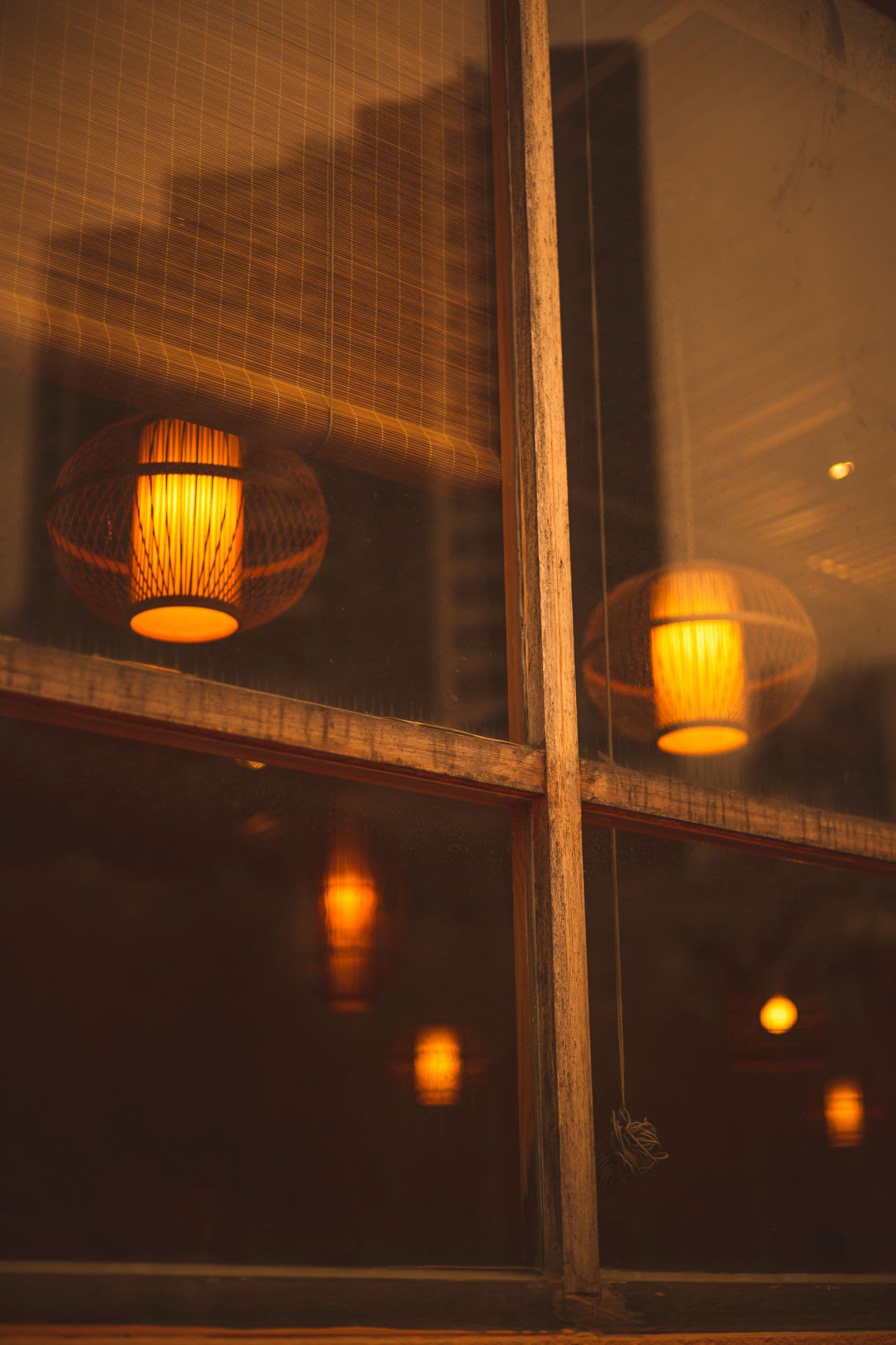 Warm indoor lamps reflecting on glass at night in Hong Kong